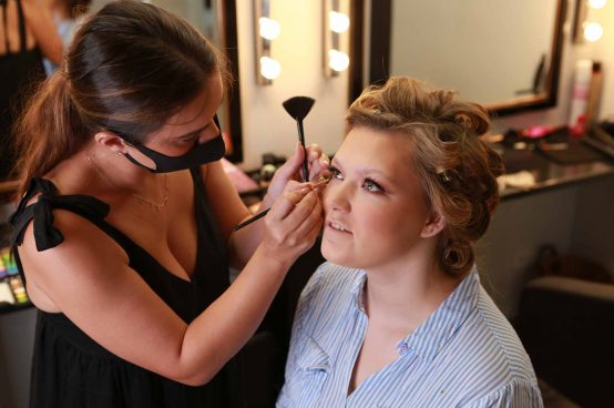 A lady getting her makeup done professionally for a glamour photoshoot